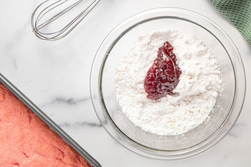 powdered sugar with strawberry jam in a glass bowl