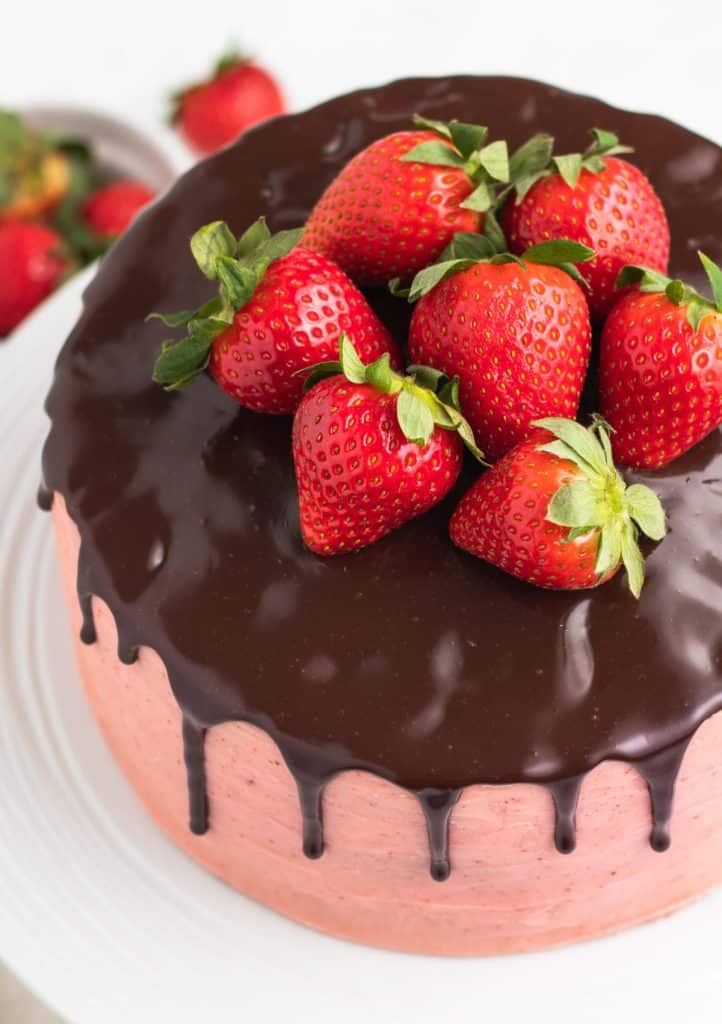 overhead view of a chocolate strawberry cake with fresh strawberries on top